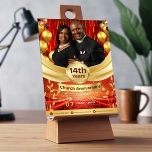 May include: A wooden easel displays a church anniversary announcement. The announcement features a couple, gold balloons, and the text "14th Years Church Anniversary" on a red and gold background. The date is December 14, 2024.