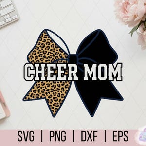 May include: A graphic design of a cheerleading bow with the text "CHEER MOM". The bow is split, with a leopard print pattern on one side and solid black on the other. The design includes the file types SVG, PNG, DXF, and EPS.
