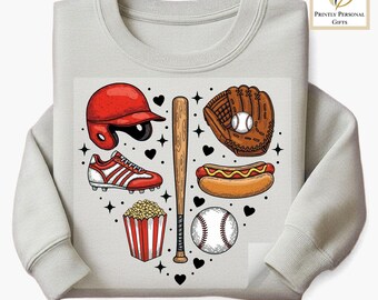 May include: A light gray sweatshirt featuring a heart-shaped design of baseball-themed illustrations. The design includes a red helmet, baseball glove, baseball bat, baseball, hot dog, popcorn, and baseball cleats. The text "DTF TRANSFER" is at the bottom.