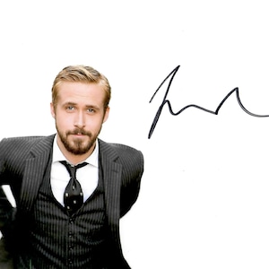 May include: A portrait of a man in a pinstripe suit, vest, and tie. The man has light brown hair and a beard. A black signature is on the right side of the image.