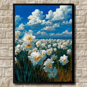 Op de afbeelding: Een ingelijste kunstdruk van een veld met witte narcissen met gele centra onder een helderblauwe lucht vol pluizige witte wolken. Het kunstwerk wordt tentoongesteld tegen een bakstenen muur met textuur.