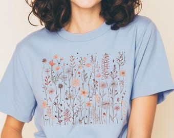 Maglietta e felpa minimaliste con stampa floreale, grafica botanica a tratto.
