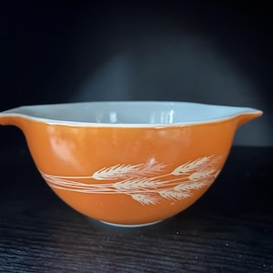 May include: A set of three ceramic mugs with a speckled, matte finish in cream, light grey, and dark grey. Each mug has a simple, minimalist design and a rounded handle.