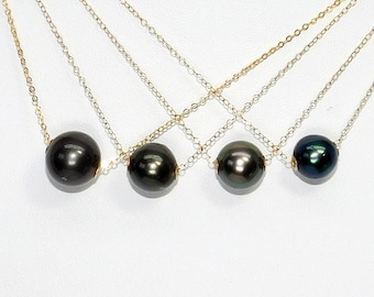 May include: Four necklaces with black pearls on gold chains. The pearls are different sizes and the chains are different lengths.