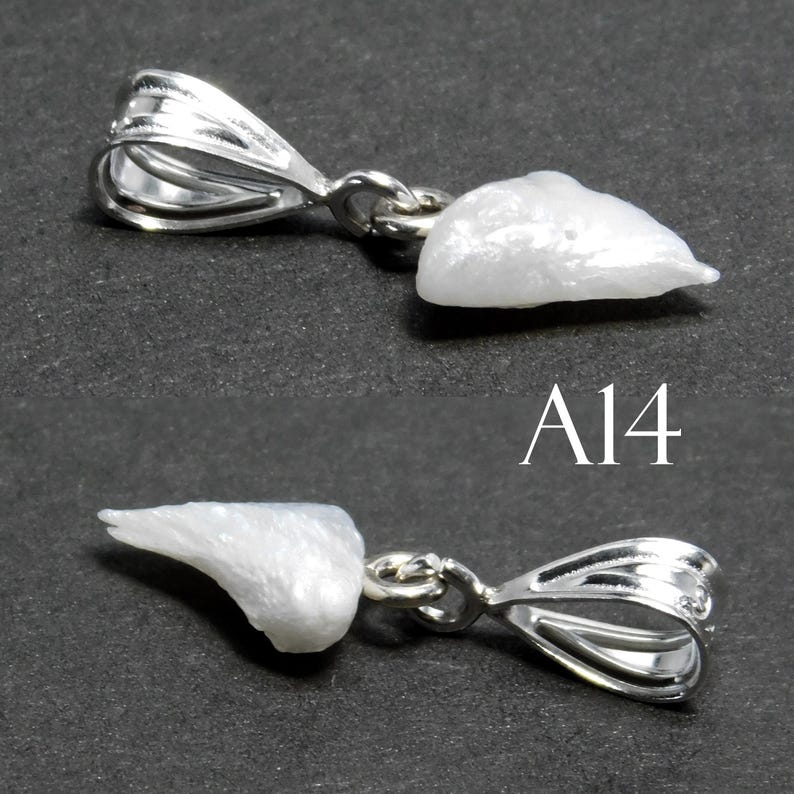May include: A white pearl pendant with a silver bail. The pearl is irregular in shape and has a rough texture. The pendant is labeled "A14".