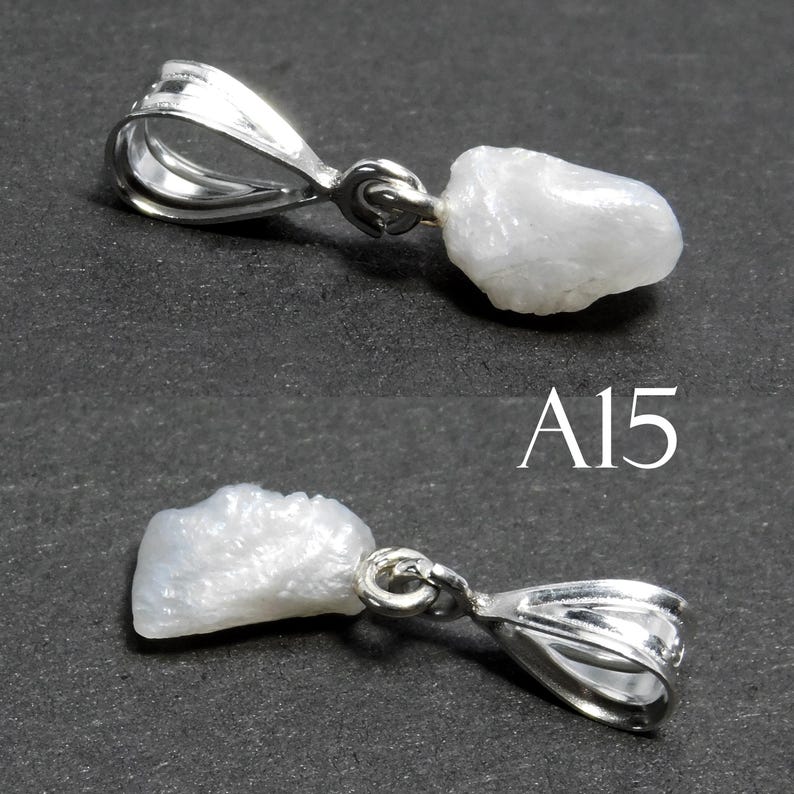 May include: A white, rough, natural gemstone pendant with a silver bail. The pendant is shown from two angles. The text "A15" is visible in the image.