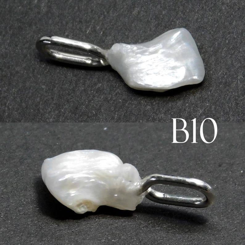 May include: Two white, irregularly shaped pearl pendants with silver-colored loops. The pendants are displayed against a dark gray background. The text "B10" is visible in white.