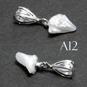 May include: A white pearl pendant with a silver bail. The pearl is irregular in shape and has a smooth, shiny surface. The bail is a simple, open loop design. The pendant is labeled "A12".
