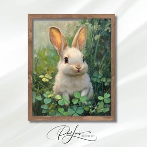 May include: A framed art print featuring a white rabbit amidst green foliage and clover. The artwork has a soft, painterly style with a wooden frame. The rabbit has long ears and dark eyes, creating a charming, nature-themed piece.