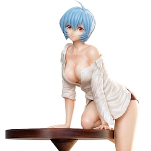 May include: A figurine of a woman with short blue hair and red eyes, wearing a white button-down shirt and brown shorts. The figure is kneeling and leaning on a dark brown table. The figurine is a collectible item.
