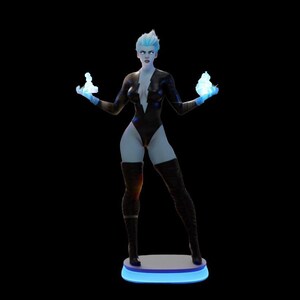 May include: A stylized figurine of a woman with blue skin and hair, wearing a black bodysuit and thigh-high boots. She holds glowing blue orbs in each hand. The figurine stands on a round, illuminated base with a blue glow against a black background.