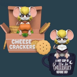 May include: Two figurines of a mouse-like character with yellow hair and large ears. One figurine is in a box of "CHEESE CRACKERS", the other is in a dark blue mug with the text "A HOT CUP OF Ballistics BEFORE BED".