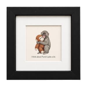 May include: A framed print featuring a gray monkey hugging a smaller orange stuffed monkey. Below the illustration, the text reads, "I think about Punch quite a lot." The artwork is set within a white mat and a thick, black square wooden frame.