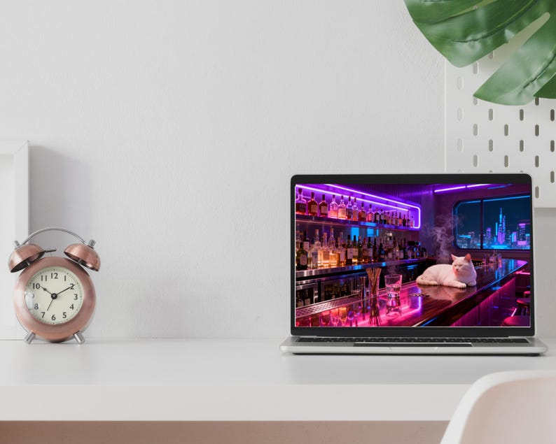 May include: A rose gold alarm clock with a white face sits next to a laptop displaying a neon-lit bar scene with a white cat. The laptop is open on a white desk. A green plant is in the background.