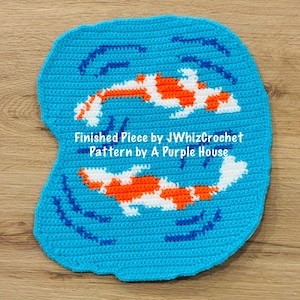 May include: A crocheted blue mat featuring two koi fish in orange and white, with blue water details. The text "Finished Piece by JWhizCrochet Pattern by A Purple House" is visible.