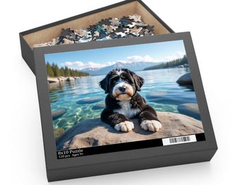 May include: A black puzzle box with a lid open, revealing a partially assembled jigsaw puzzle. The puzzle image features a black and white dog resting on a rock by a lake. The box reads "8x10 Puzzle" and "120 pcs Ages 9+".