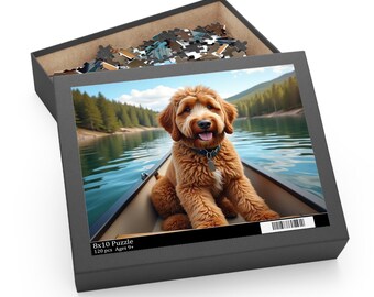 May include: A jigsaw puzzle box with an image of a golden doodle dog in a canoe on a lake. The puzzle box is black and has the text "8x10 Puzzle" and "120 pcs Ages 9+". The puzzle pieces are visible inside the box.