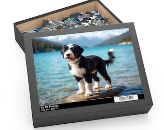 May include: A black puzzle box with a completed 8x10 puzzle featuring a black and white dog standing on a rock in front of a lake and mountains. The box is open, revealing puzzle pieces. Text on the box reads "8x10 Puzzle 120 pcs Ages 9+".