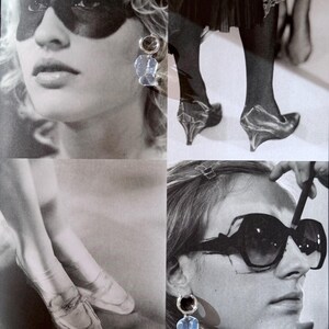 May include: A collage of black and white photographs featuring clear, irregular-shaped drop earrings with silver-toned hoops. The images display the earrings worn alongside various fashion elements, including dark eye makeup, sheer hosiery, and sunglasses.