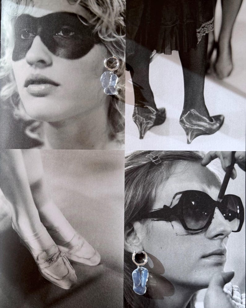 May include: A collage of black and white photographs featuring clear, irregular-shaped drop earrings with silver-toned hoops. The images display the earrings worn alongside various fashion elements, including dark eye makeup, sheer hosiery, and sunglasses.