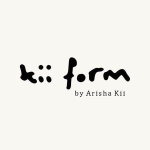 May include: A black logo on a cream background featuring the text kii form in a stylized, hand-drawn font. Below the main text, the words by Arisha Kii appear in a smaller, clean, serif typeface, completing the brand identity graphic design.
