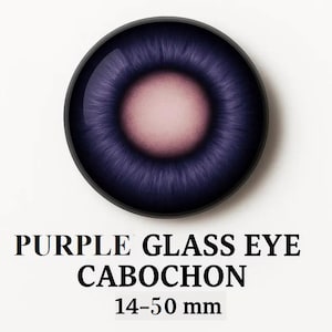 May include: A round, purple glass eye cabochon with a dark outer ring and a light pink center. The iris has a detailed, textured appearance. Text at the bottom reads "PURPLE GLASS EYE CABOCHON 14-50 mm."