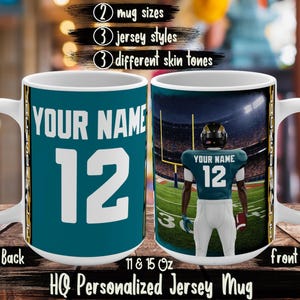 May include: A white ceramic mug with a teal jersey design, featuring the text "YOUR NAME" and the number "12". The front of the mug shows a football player in a stadium. The mug is available in 11 and 15 oz sizes.