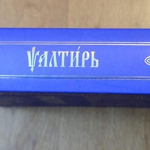 May include: A set of three ceramic mugs with a speckled, matte finish. The mugs are in shades of cream, light gray, and dark gray. Each mug has a simple, minimalist design and a rounded handle.