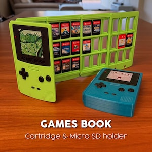May include: A lime green cartridge and micro SD card holder shaped like a retro handheld game console. The holder is open, displaying several game cartridges. A teal handheld game console is next to the holder. The text "GAMES BOOK" is visible.