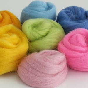 Balls of Merino wool tops in 7 pretty colours - dark blue and light blue, tangerine, lime, yellow, bright pink and dusky pink