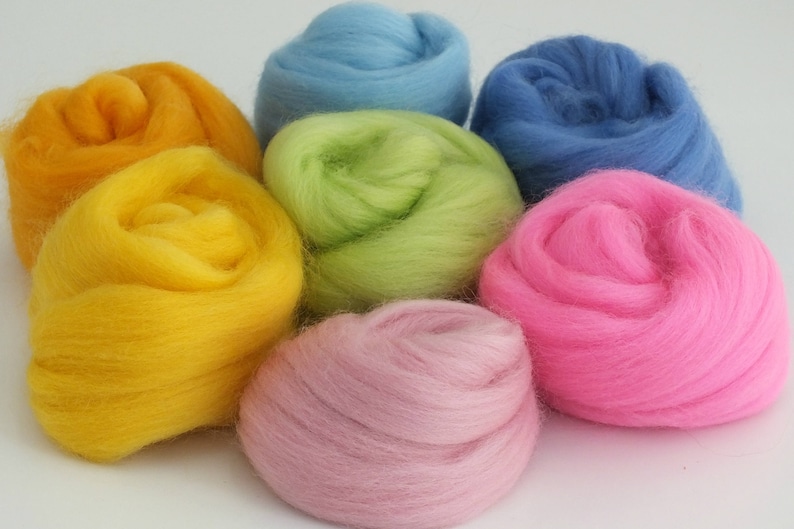 Balls of Merino wool tops in 7 pretty colours - dark blue and light blue, tangerine, lime, yellow, bright pink and dusky pink