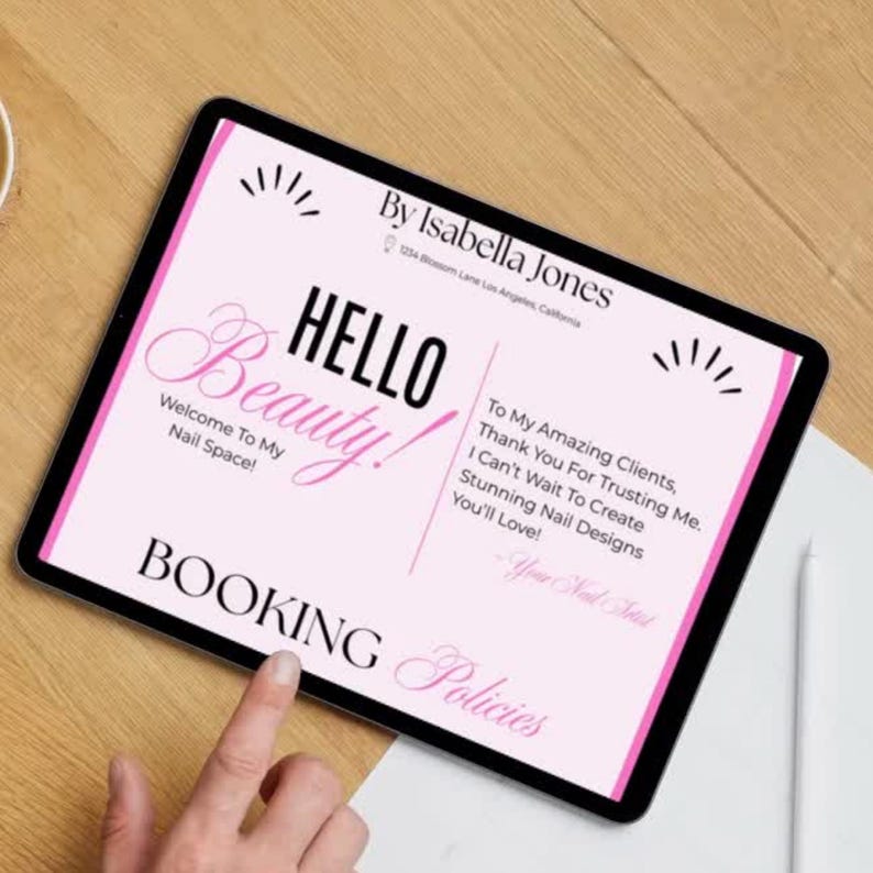 May include: A digital tablet displays a pink graphic with the text "HELLO Beauty!" and "Welcome To My Nail Space!" The tablet also includes the text "BOOKING Policies" and "By Isabella Jones". A finger points at the screen.