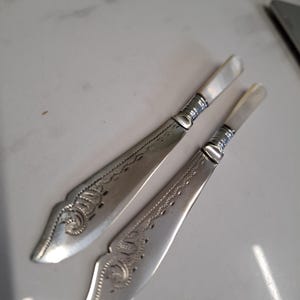 antique matching pair of silver plate mother of pearl butter knives