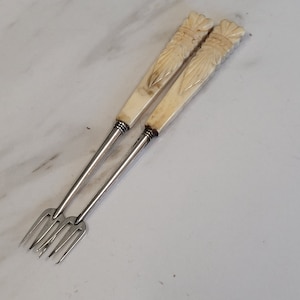 antique pair of silver plate carved handle sea food forks