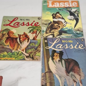Op de afbeelding: Drie vintage Lassie-strips. De covers tonen illustraties van Lassie, een colliehond, in verschillende scènes. De strips hebben de tekst "Lassie" in een gestileerd lettertype, met het MGM-logo.