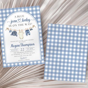 May include: A baby shower invitation card featuring a blue and white gingham border, an arched frame, and a clothesline illustration with baby clothing. The text reads A BLUE jean baby IS ON THE WAY, Megan Thompson, August 22 at 2PM, and registry details.