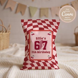 May include: A red and white checkered party favor bag with a pink rectangular label. The label reads "Ellie's 67 7th Birthday" with cherry illustrations. The bag is on a white textured surface.