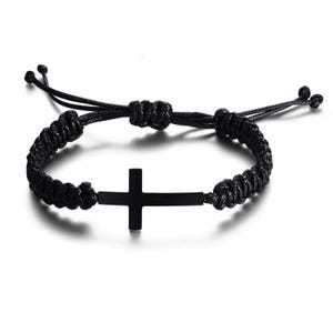 May include: Black braided bracelet featuring a matte black cross pendant. The adjustable bracelet is made of woven black cord and has a sliding knot closure. The cross is centered on the bracelet.