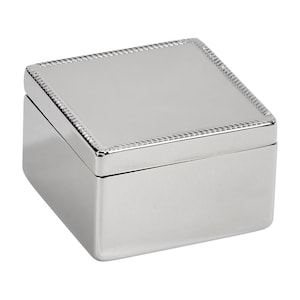 May include: A square, silver-colored box with a hinged lid. The lid has a decorative rope-like border. The box is made of a shiny, reflective material, and the edges are smooth and rounded. The box is likely used for storing jewelry or small keepsakes.