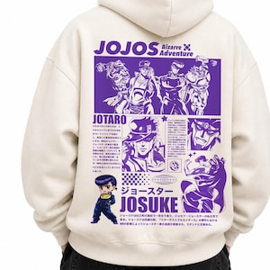 May include: A cream-colored hooded sweatshirt featuring a large purple graphic print on the back. The design includes illustrations of characters from JoJo's Bizarre Adventure, along with Japanese text, the title JOJOS Bizarre Adventure, and names.