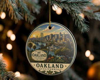 May include: A round ceramic ornament featuring a detailed illustration of the Oakland, California skyline at sunset, including the Bay Bridge. The text reads Welcome to Oakland California Est. 1852 and Love Life Love Oakland with a gold string.