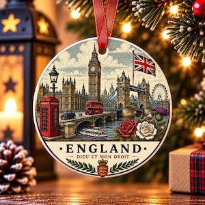 May include: A round ceramic ornament featuring a detailed illustration of the London skyline, including Big Ben, Tower Bridge, a red telephone box, and a double-decker bus. The text reads ENGLAND and DIEU ET MON DROIT above a royal crest.