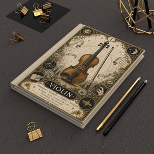 May include: A rectangular notebook with a cream-coloured cover featuring a detailed illustration of a violin and bow. The cover includes the text VIOLIN, musical notes, celestial symbols, and floral motifs. The design is printed in shades of brown and black.