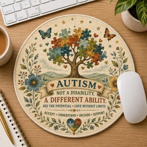 May include: A round mouse pad featuring a tree with puzzle piece leaves in various colors, butterflies, and flowers. The text reads: AUTISM NOT A DISABILITY, A DIFFERENT ABILITY. SEE THE POTENTIAL LOVE WITHOUT LIMITS ACCEPT UNDERSTAND INCLUDE SUPPORT.