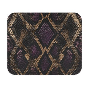 May include: A rectangular mouse pad featuring a repeating diamond-shaped snakeskin pattern in shades of deep purple, black, and metallic bronze. The surface displays a textured scale design with rounded corners and a consistent, high-contrast print.