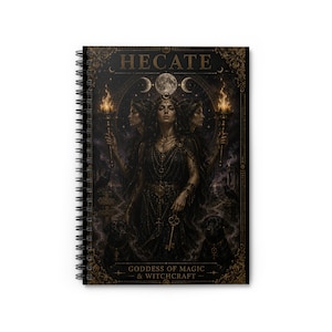 May include: Spiral-bound notebook featuring a detailed illustration of Hecate, the goddess of magic and witchcraft. The artwork depicts Hecate with three faces, holding torches and a key, with the text "HECATE" and "GODDESS OF MAGIC & WITCHCRAFT" displayed in gold.