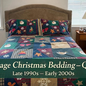 May include: Queen-size vintage Christmas bedding set. The quilt and pillowcases feature a patchwork design with festive motifs like snowmen, gingerbread men, and snowflakes. The colour palette includes shades of blue, green, red, and brown. The text on the image reads "Vintage Christmas Bedding - Queen Late 1990s - Early 2000s."