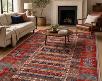 May include: A rectangular area rug with a vibrant, geometric design. The rug features a central panel with horizontal stripes in shades of red, blue, and orange, framed by patterned borders. The rug is placed in a living room setting.