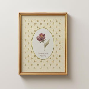 May include: A framed floral print featuring a watercolor painting of a maroon flower with a green leaf, set against a cream-colored background with a gold frame. The print includes the text "Your worries are new every morning."