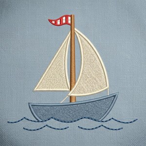 May include: Embroidered sailboat design featuring a blue boat with cream-colored sails and a brown mast. A red and white striped pennant flies from the top of the mast. The boat sails on blue embroidered waves against a light blue background.